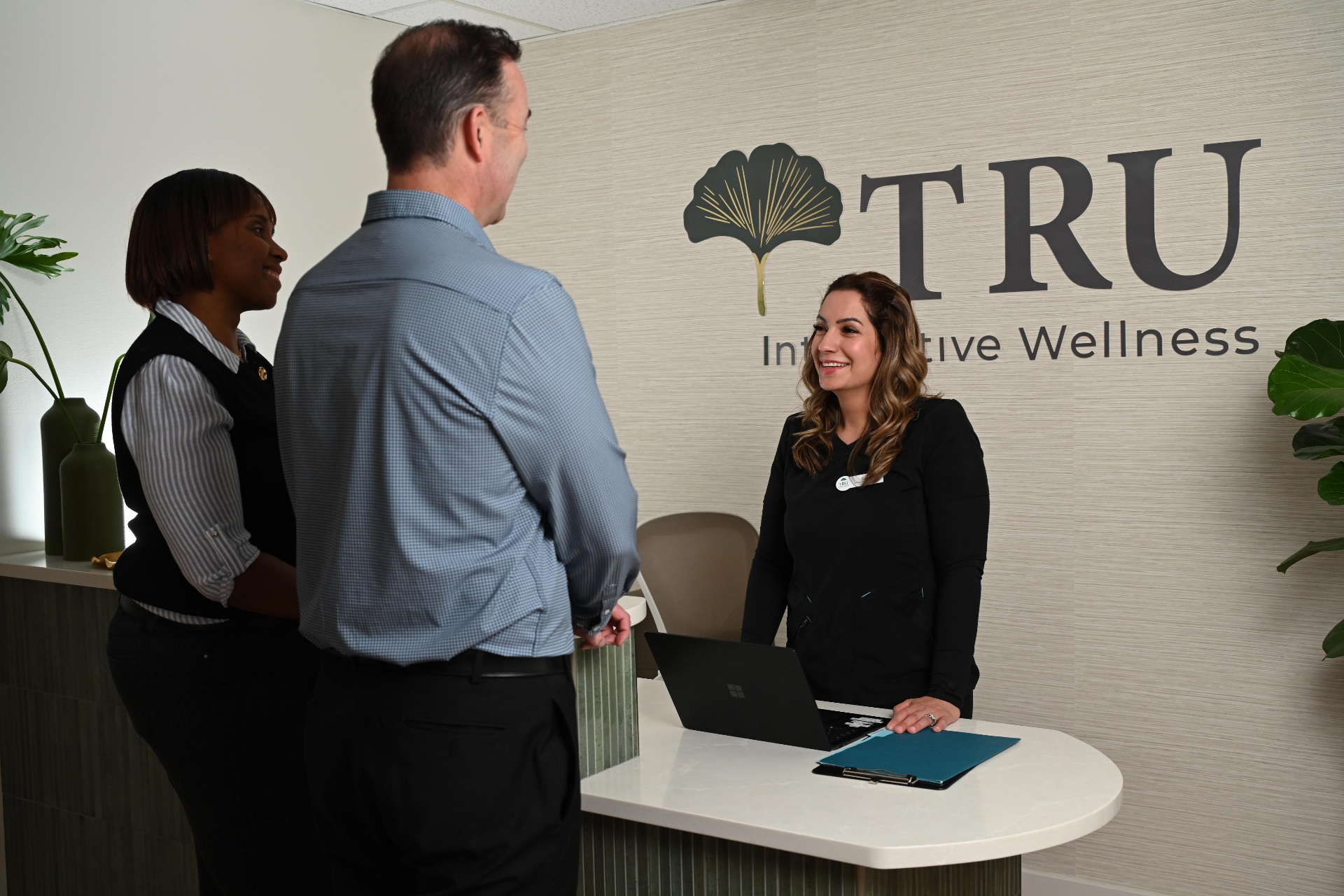 TRU Integrative Wellness front desk team welcoming a patient